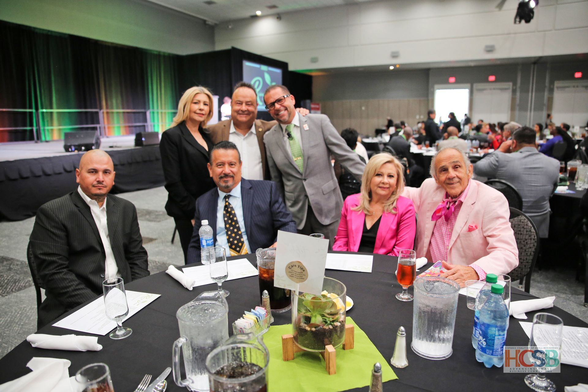A group of people are sitting around a table at a conference.