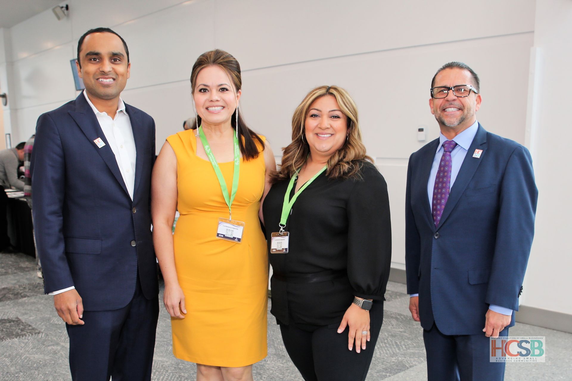 A group of people in suits are posing for a picture