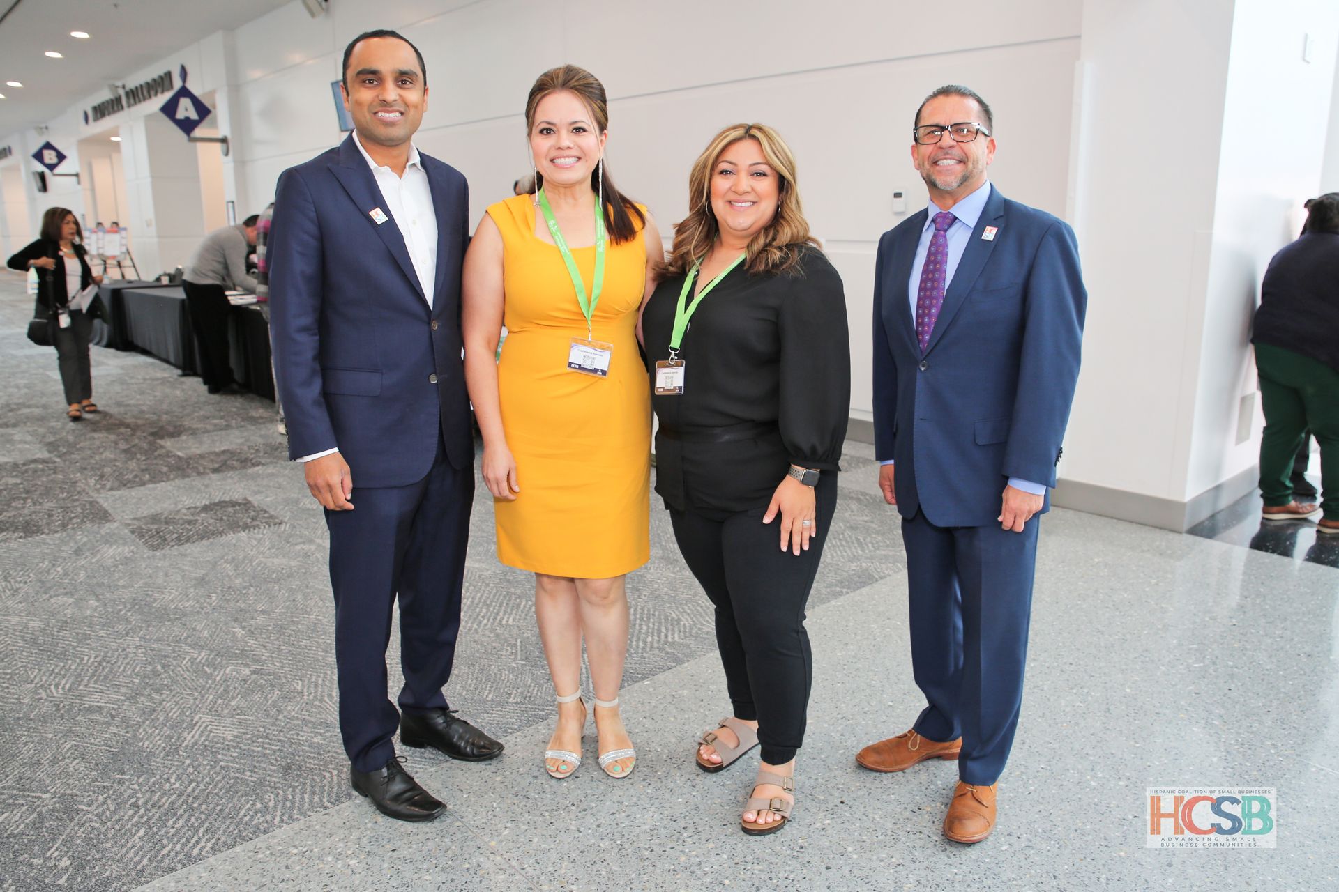 A group of people are posing for a picture in a hallway.