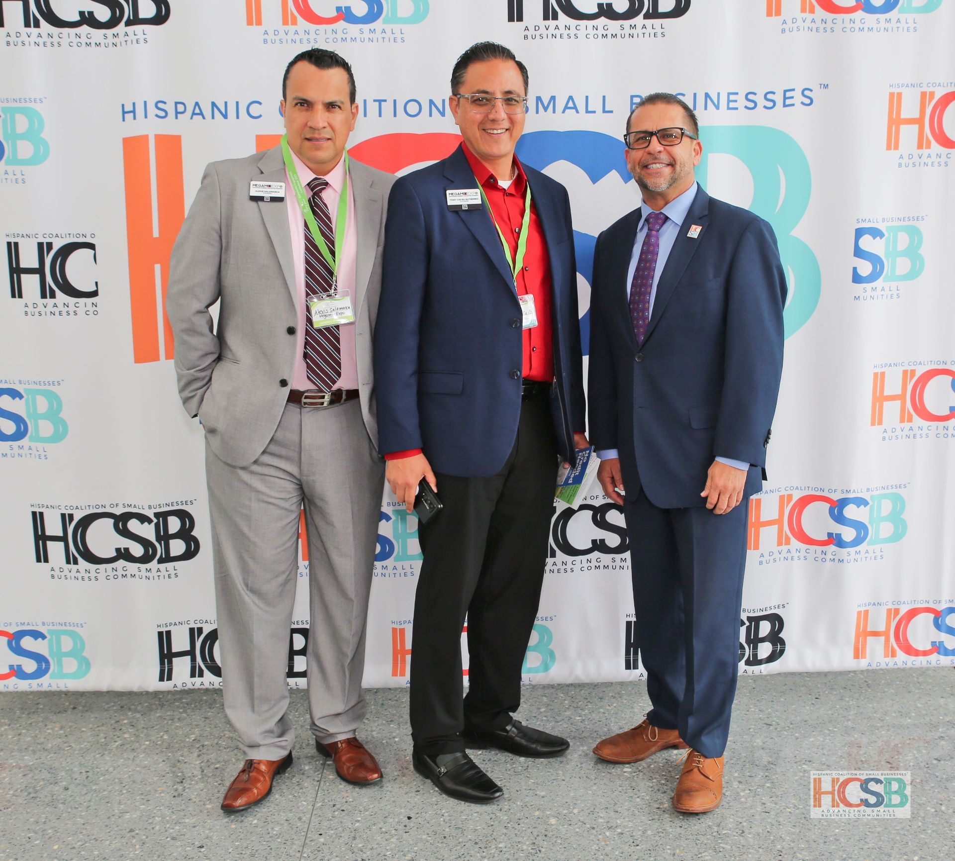 Three men standing in front of a wall that says hispanic business
