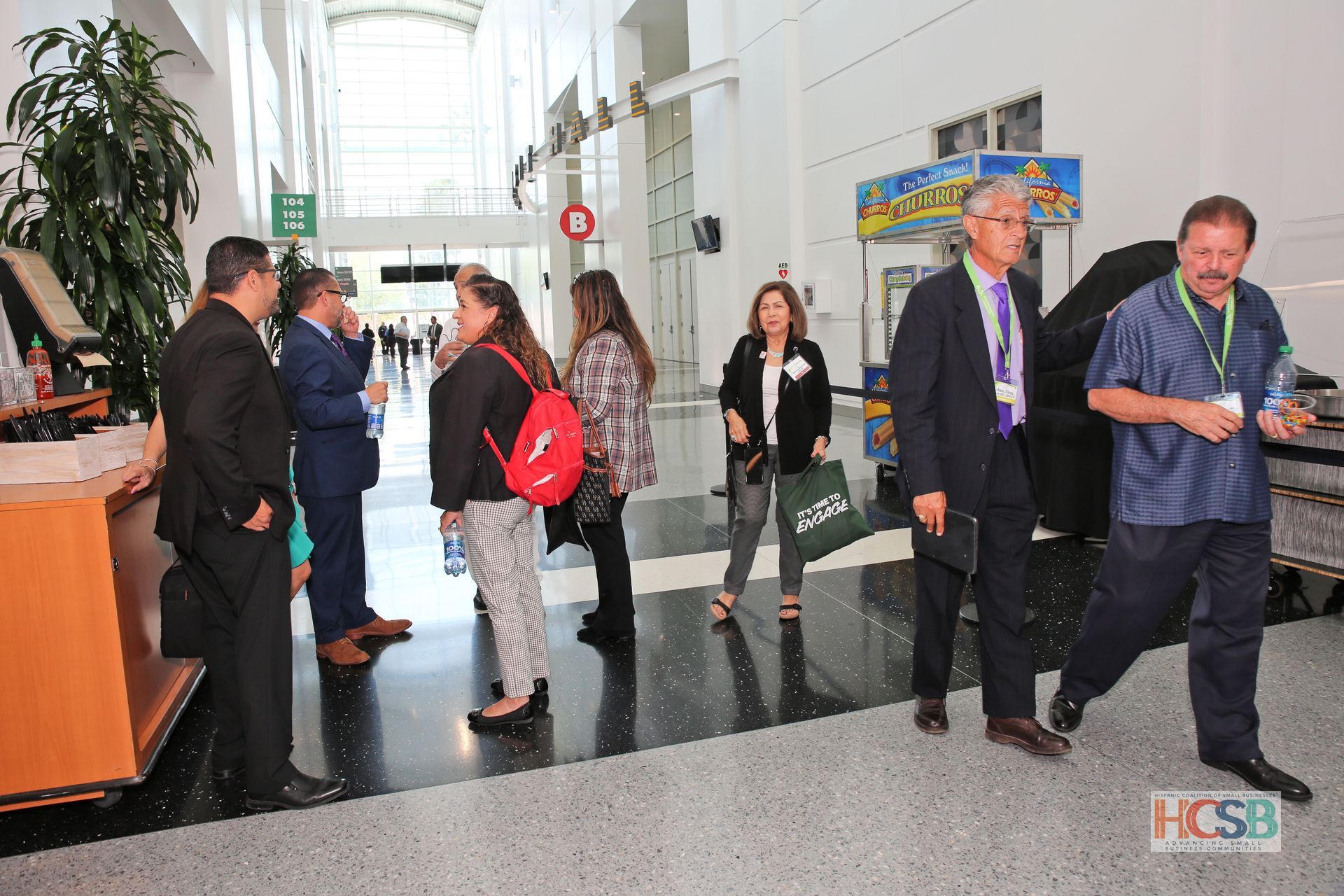 A group of people standing in a hallway with the word hcsb on the bottom