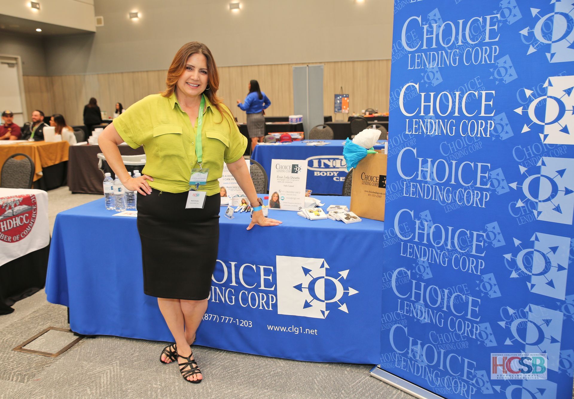 A woman standing in front of a choice lending corp table