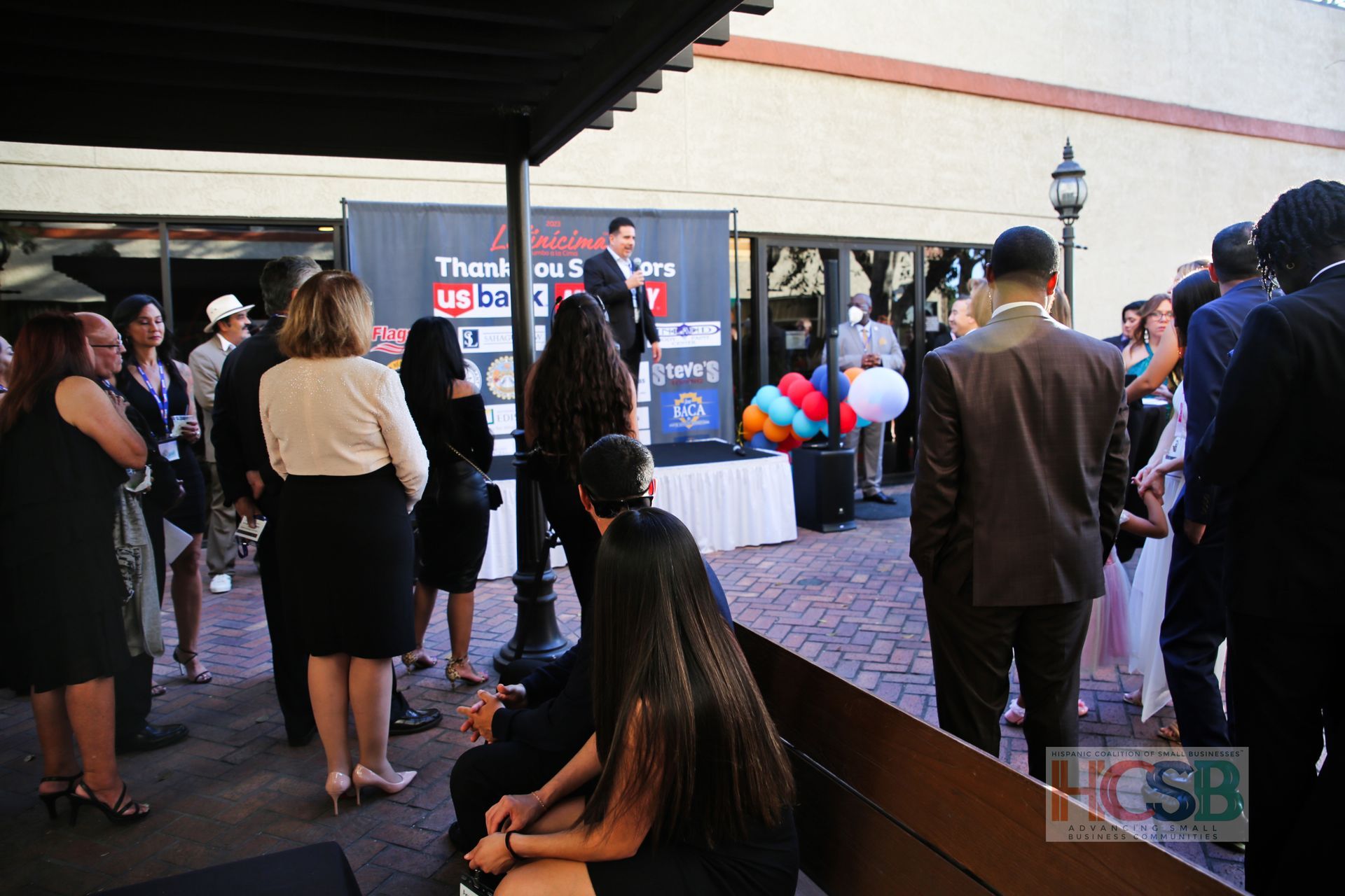 A group of people standing in front of a sign that says ucsb