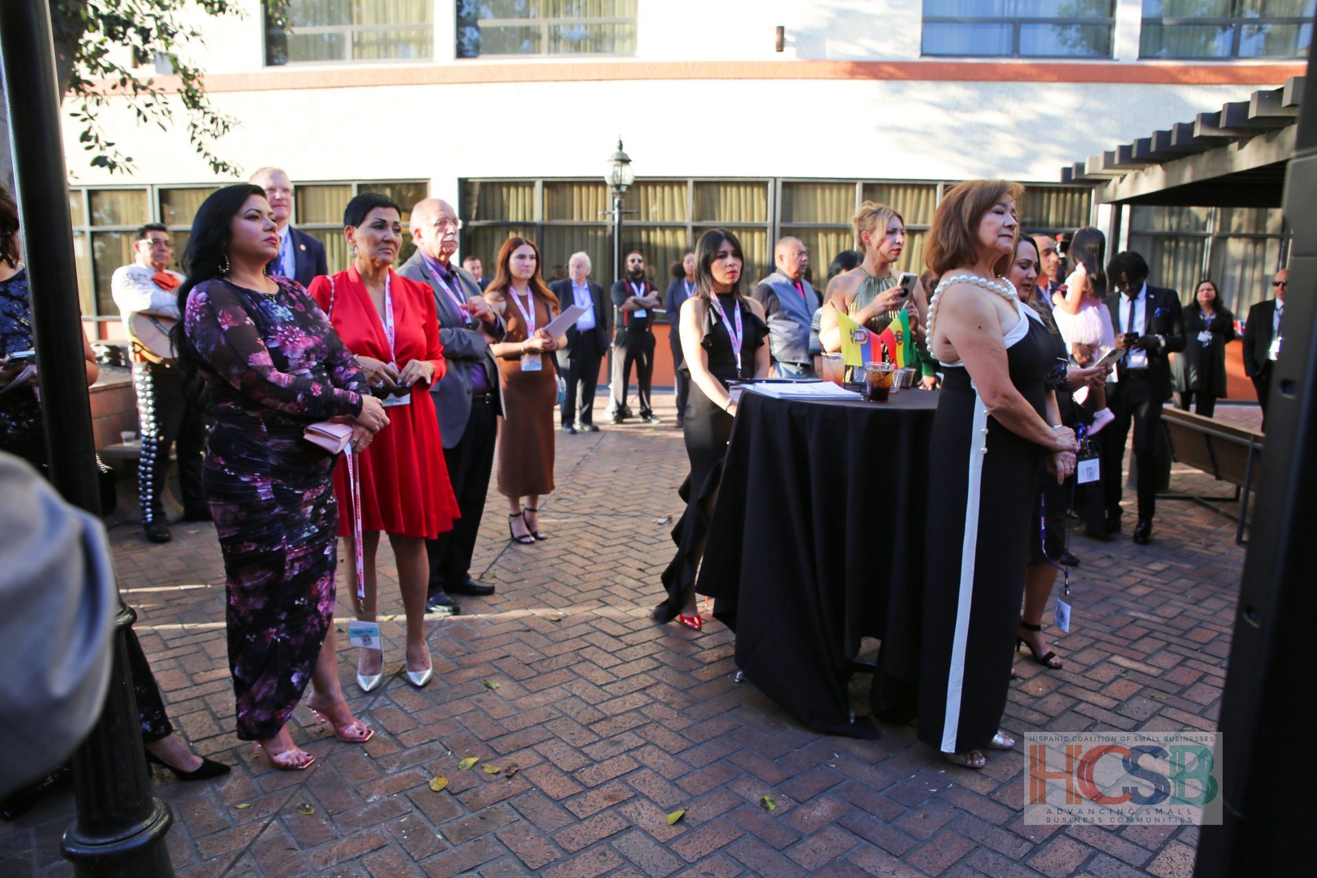 A group of people standing around a table with a hcsb logo in the corner