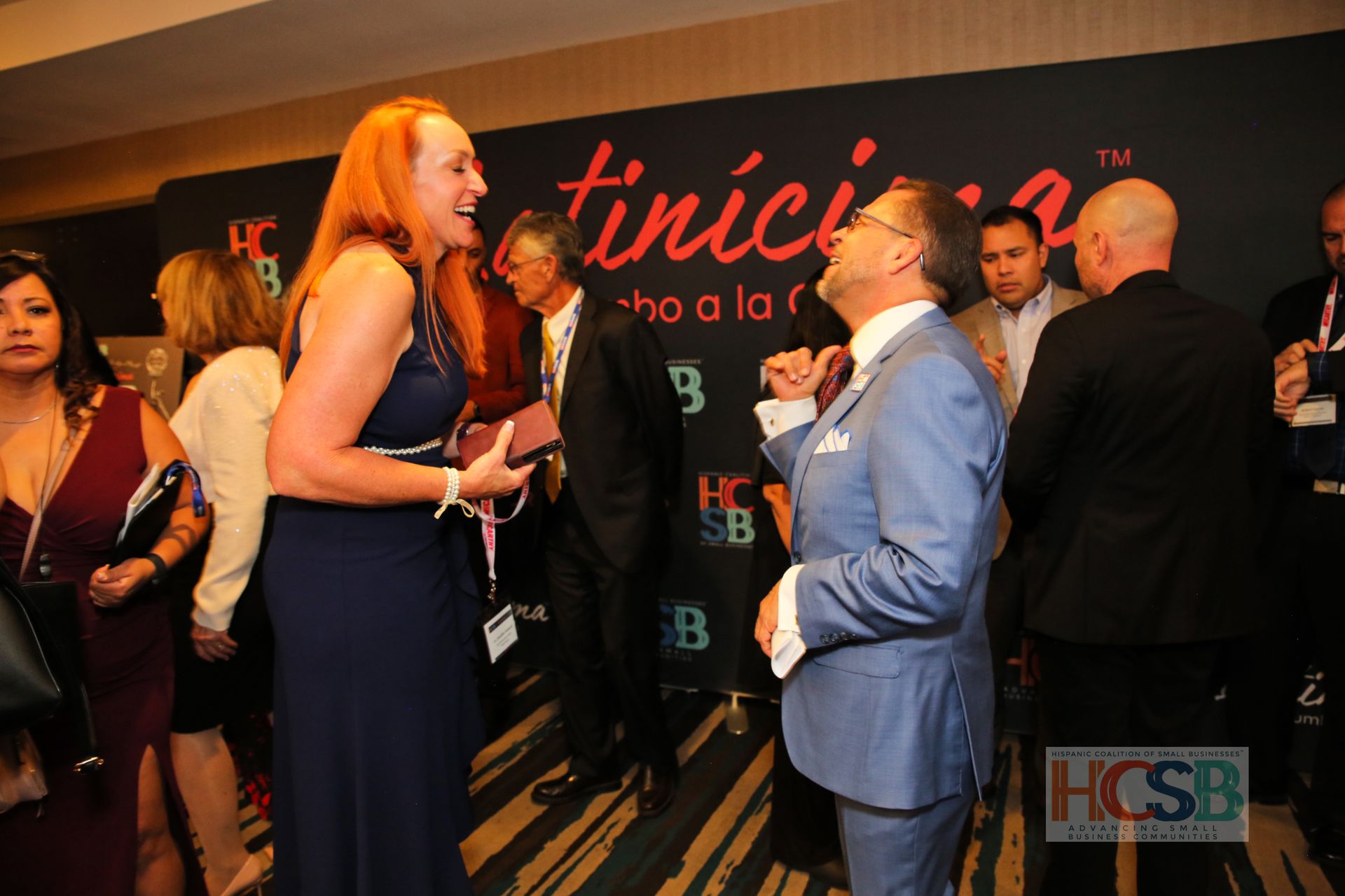 A group of people standing in front of a sign that says hcsb