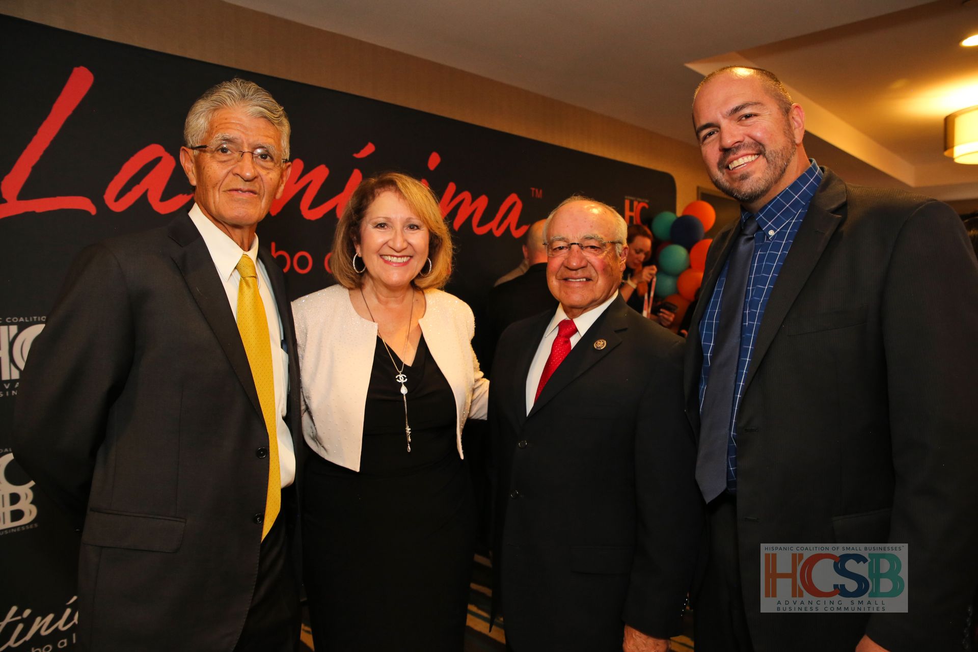 A group of people standing in front of a wall that says la rimina