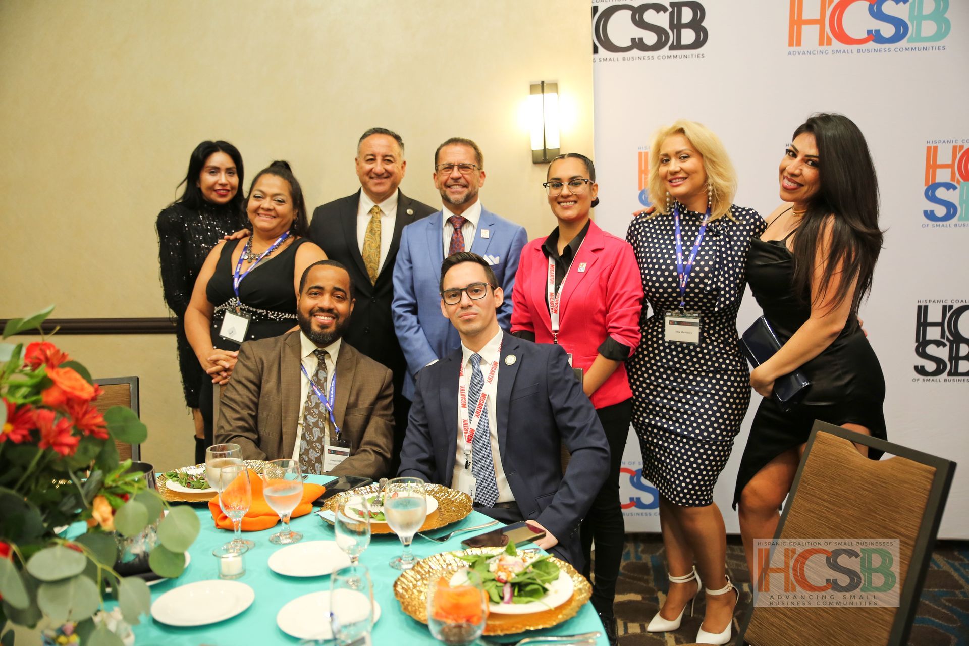 A group of people are posing for a picture at a table.