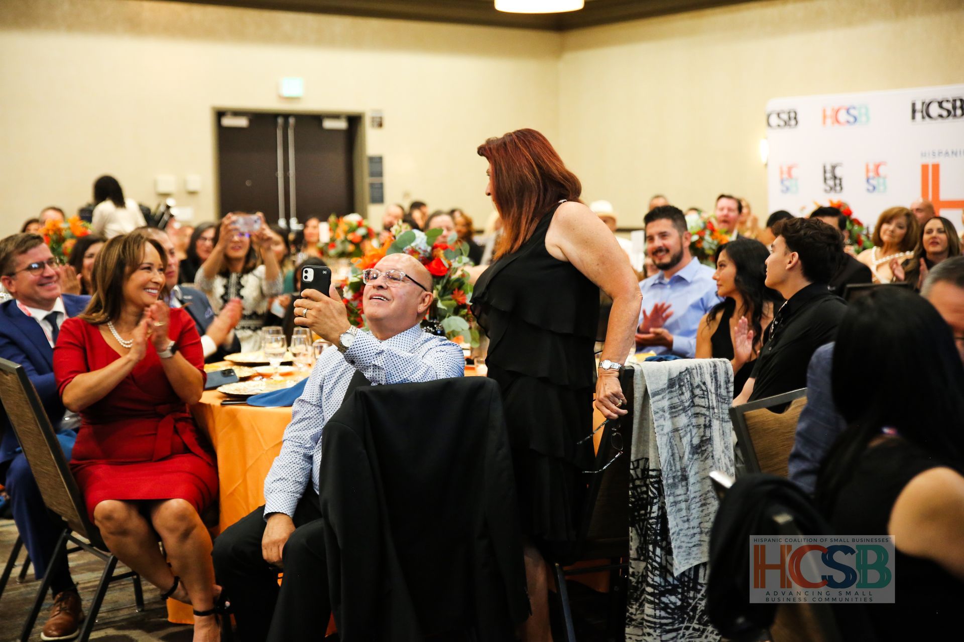 A group of people are sitting at tables in a room.