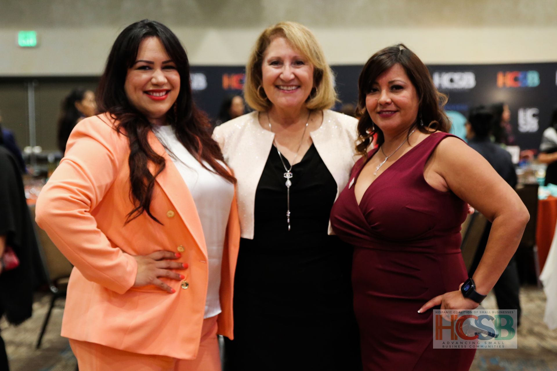 Three women are posing for a picture together in a room.