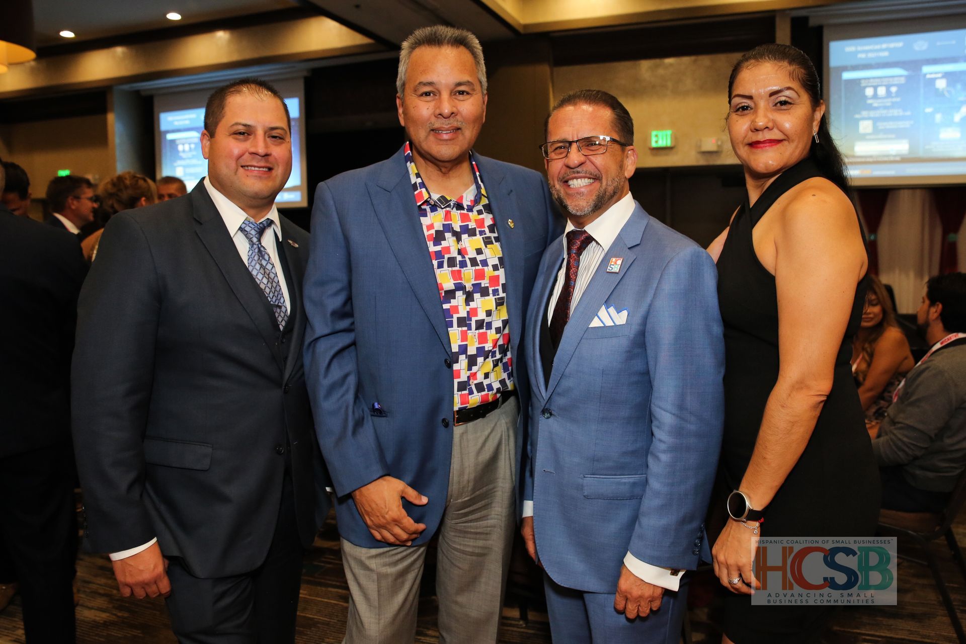 A group of men in suits and ties are posing for a picture.