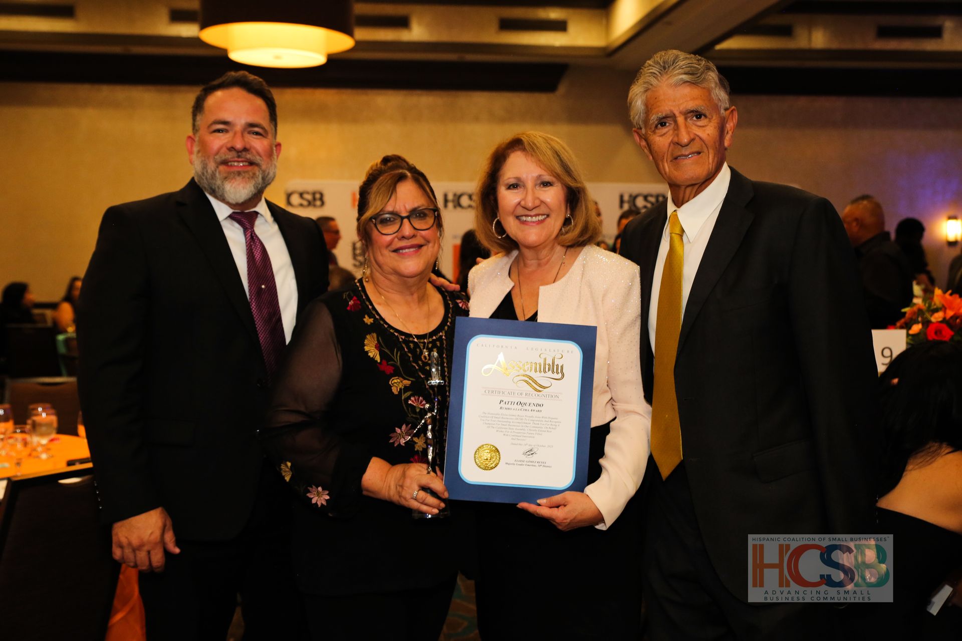 A group of people standing next to each other holding a certificate