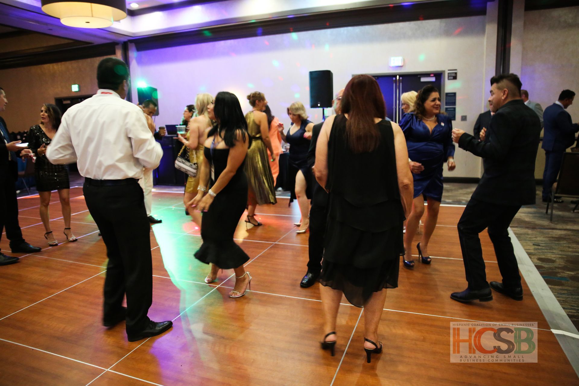 A group of people are dancing on a dance floor.