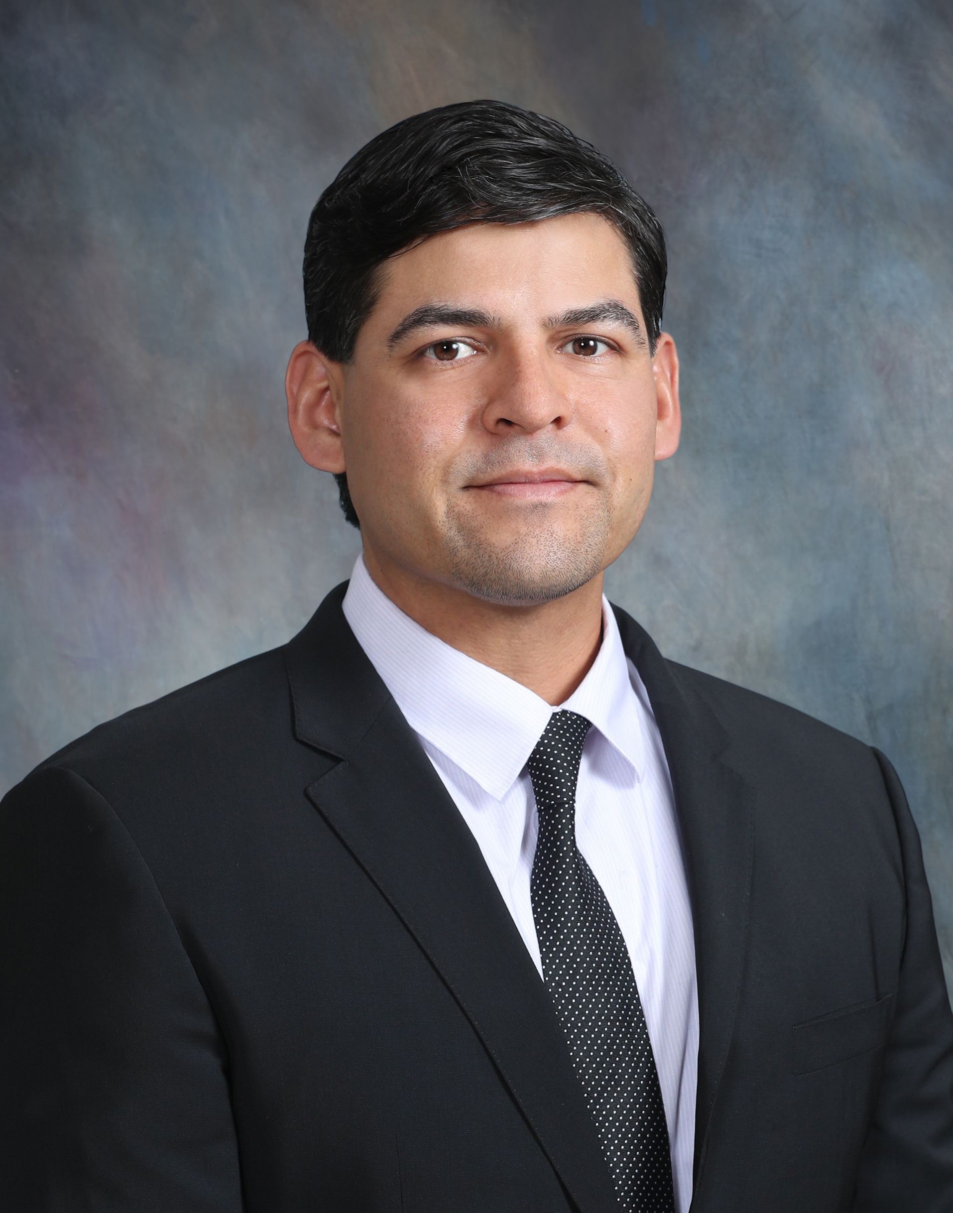 A man in a suit and tie poses for a picture