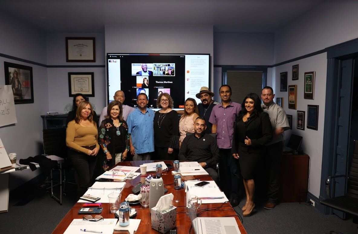 A group of people are posing for a picture in a conference room.