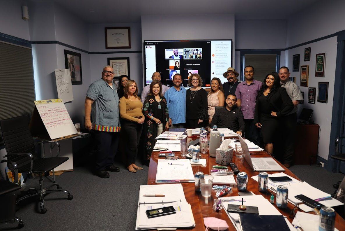 A group of people are posing for a picture in a conference room.