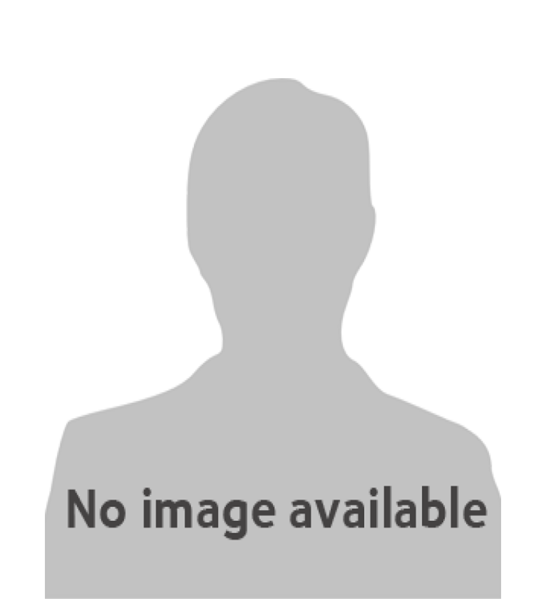 A man in a suit and plaid shirt is smiling for the camera.