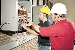 commercial electricians fixing wires
