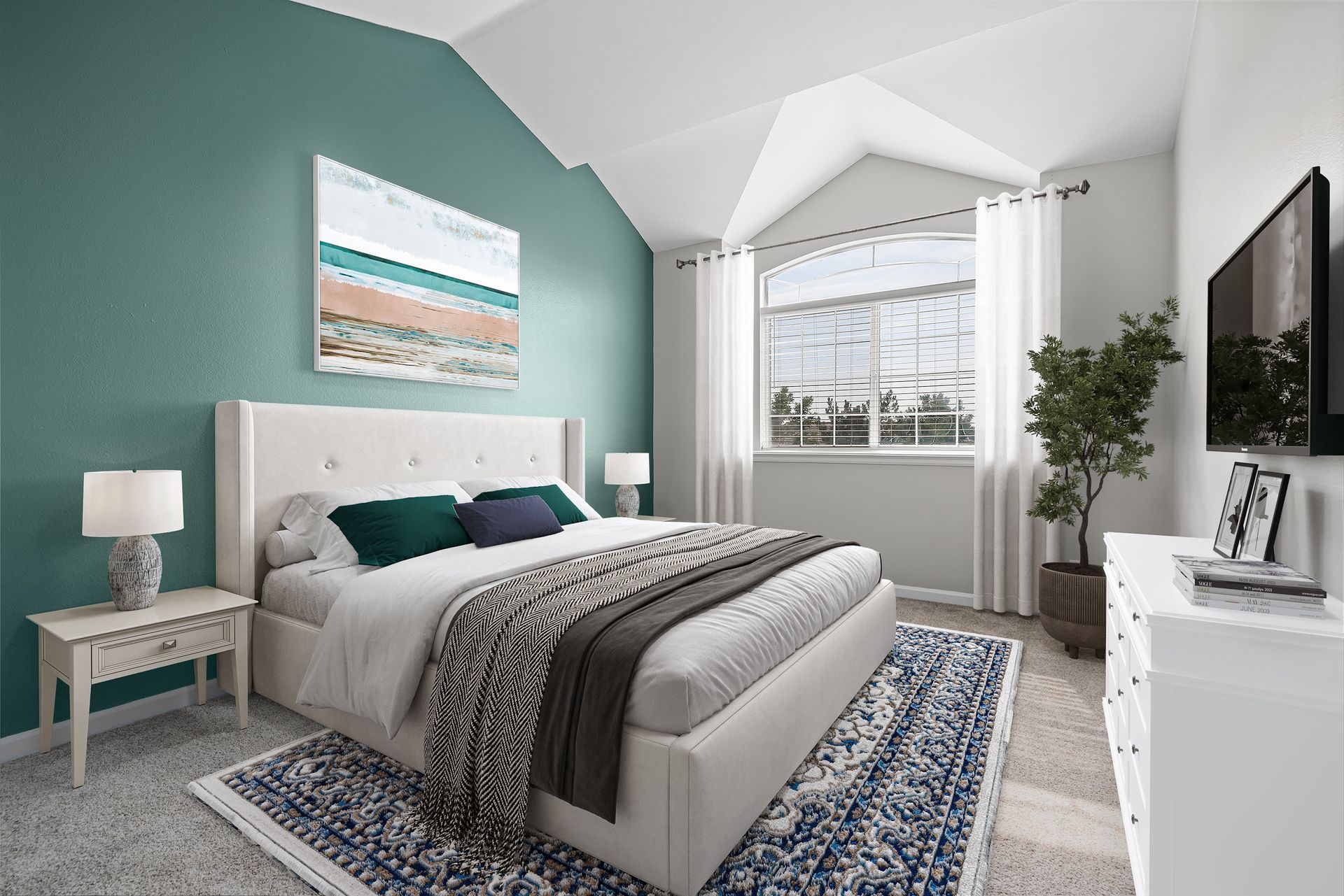 Bedroom with teal accent wall, upholstered bed, white furniture, window with white curtains, and a patterned rug.