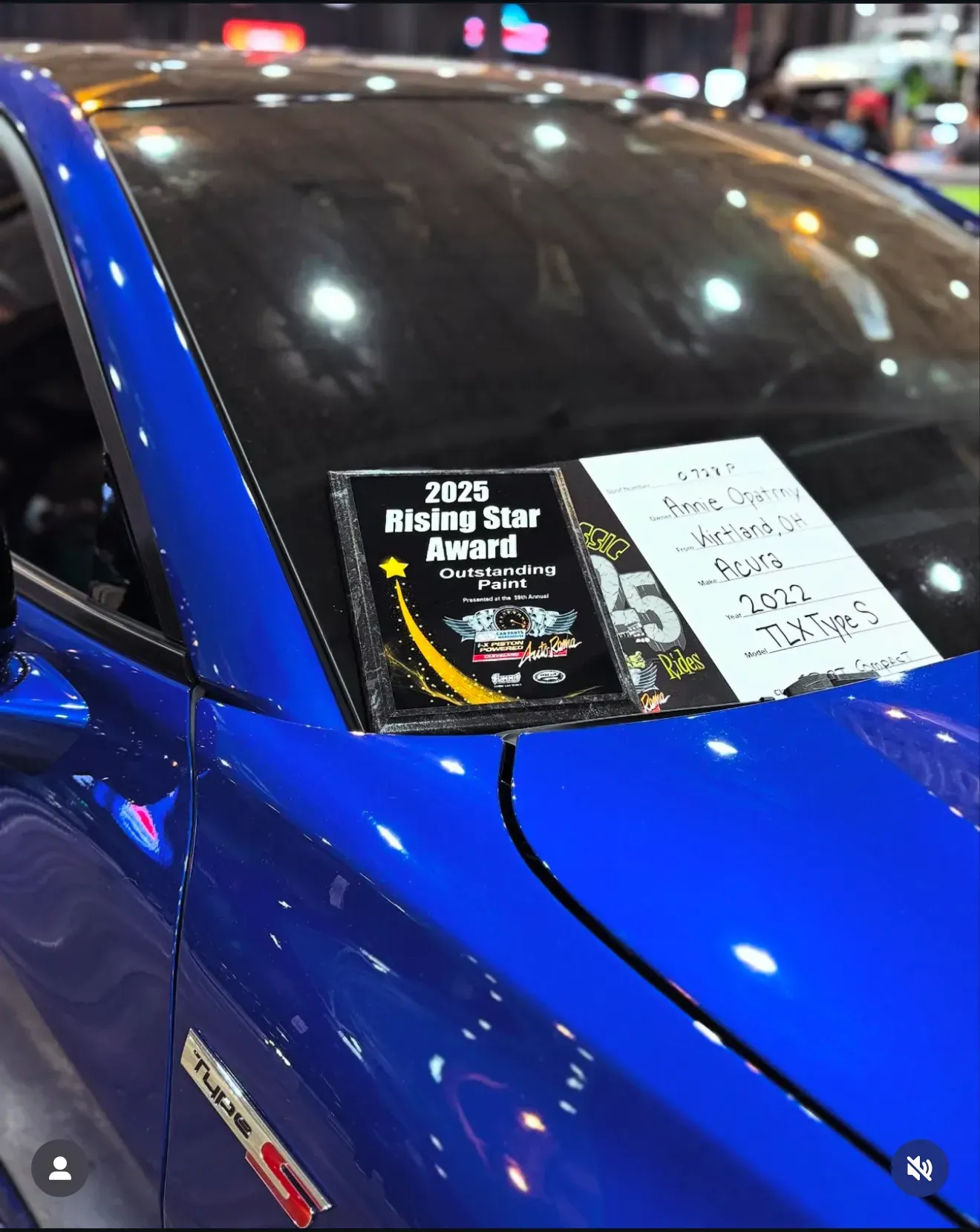 Blue Acura with painted coat on it. 