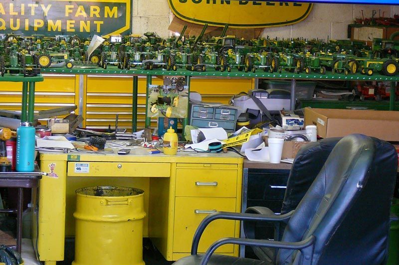 A john deere sign hangs above a yellow desk