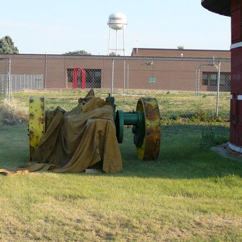 A water tower is in the background of a grassy field