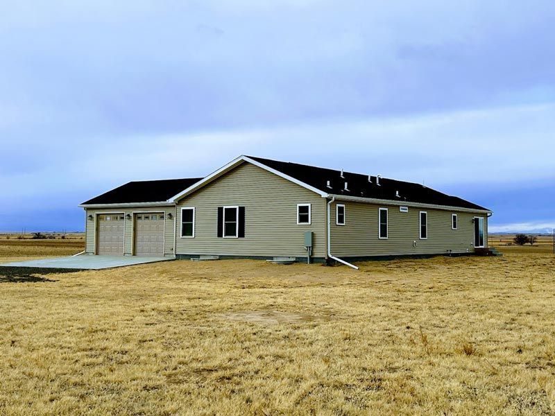 A house in the middle of a dry grass field