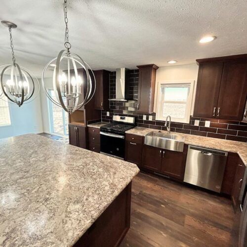 A kitchen with granite counter tops and stainless steel appliances