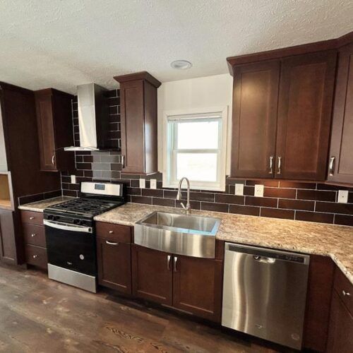 A kitchen with stainless steel appliances and wooden cabinets