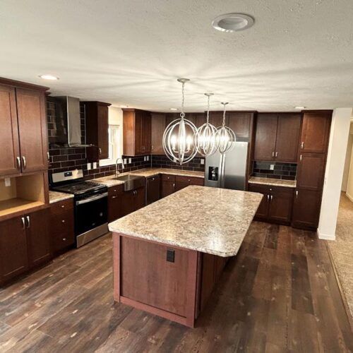 A kitchen with a large island and granite counter tops