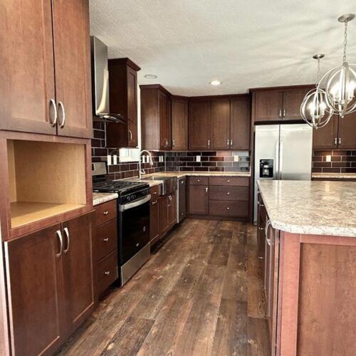 A kitchen with stainless steel appliances and wooden cabinets