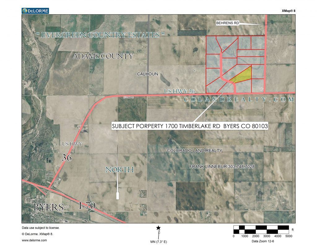 An aerial view of a ranch with a yellow triangle in the middle