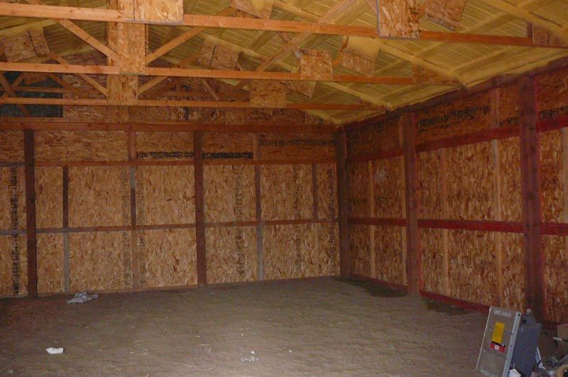 A large empty room with a wooden ceiling and walls.