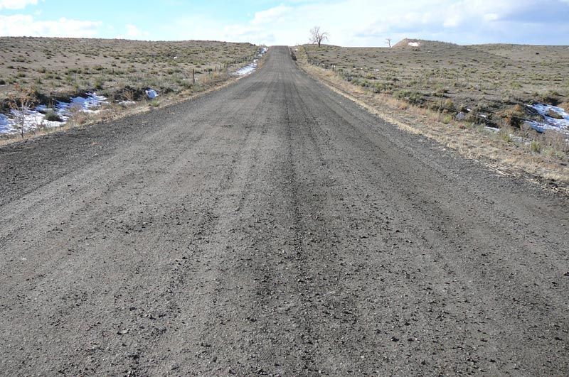 A dirt road in the middle of a desert.