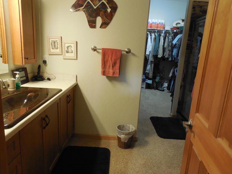 A bathroom with a sink and a trash can