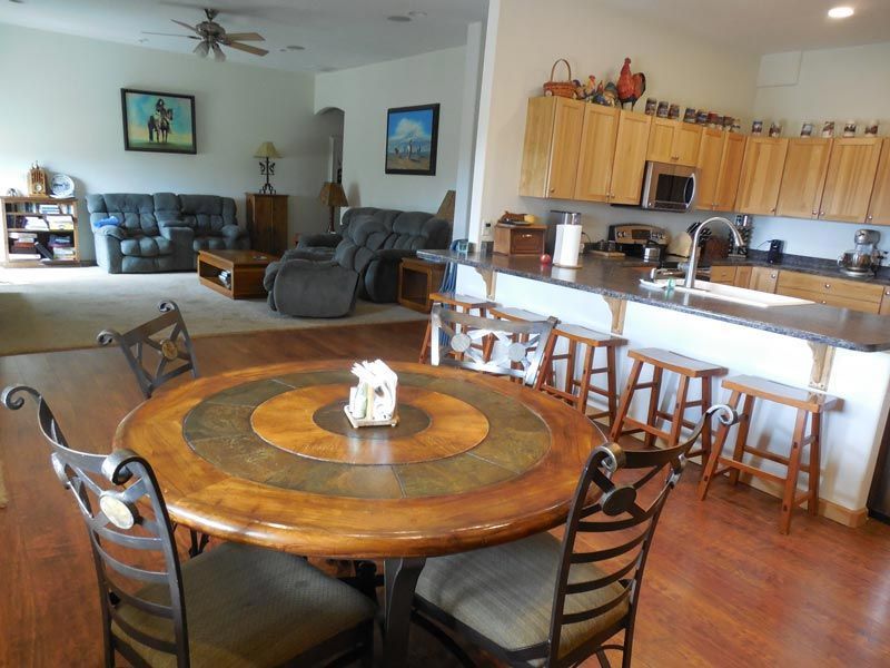 A living room with a round table and chairs