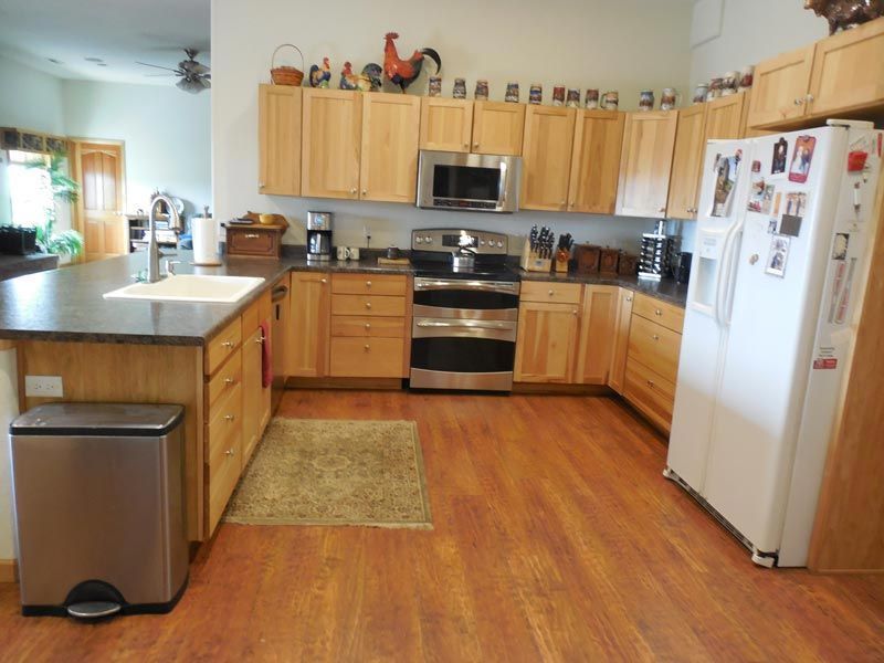 A kitchen with stainless steel appliances and wooden cabinets