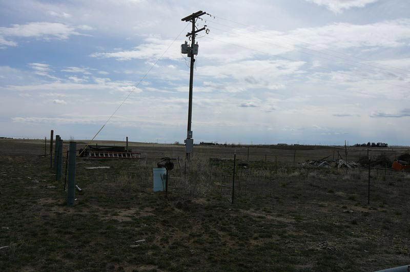 A telephone pole in the middle of a field