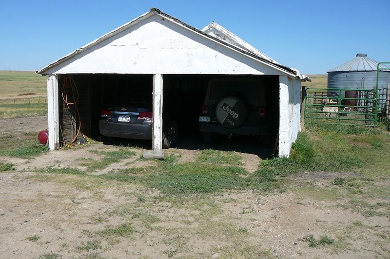 A jeep is parked in a white garage