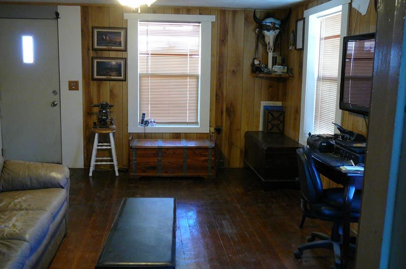 A living room with a couch and a desk