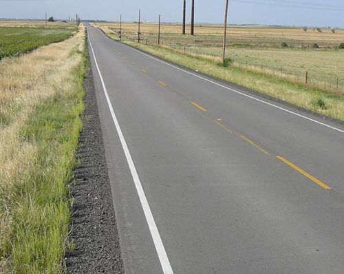 A road with a white line on the side of it