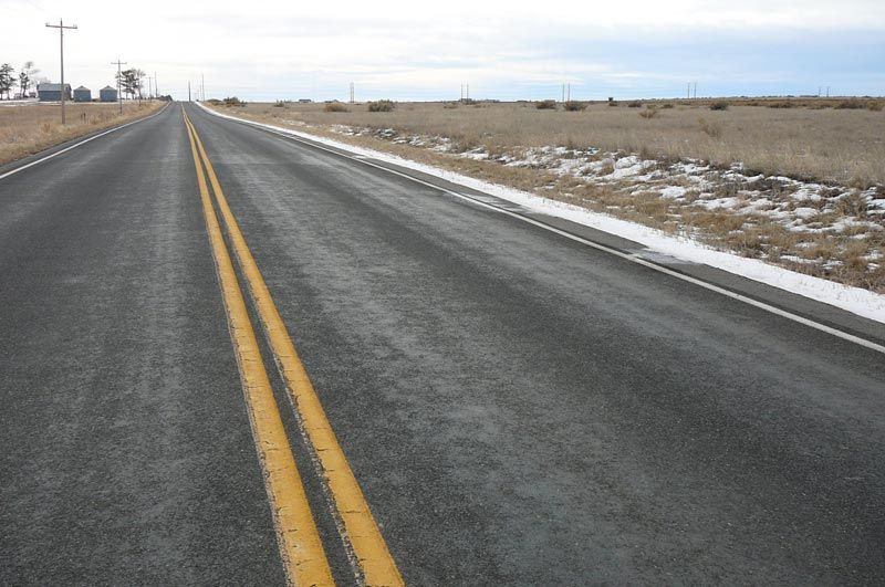 A road with a yellow line on the side of it