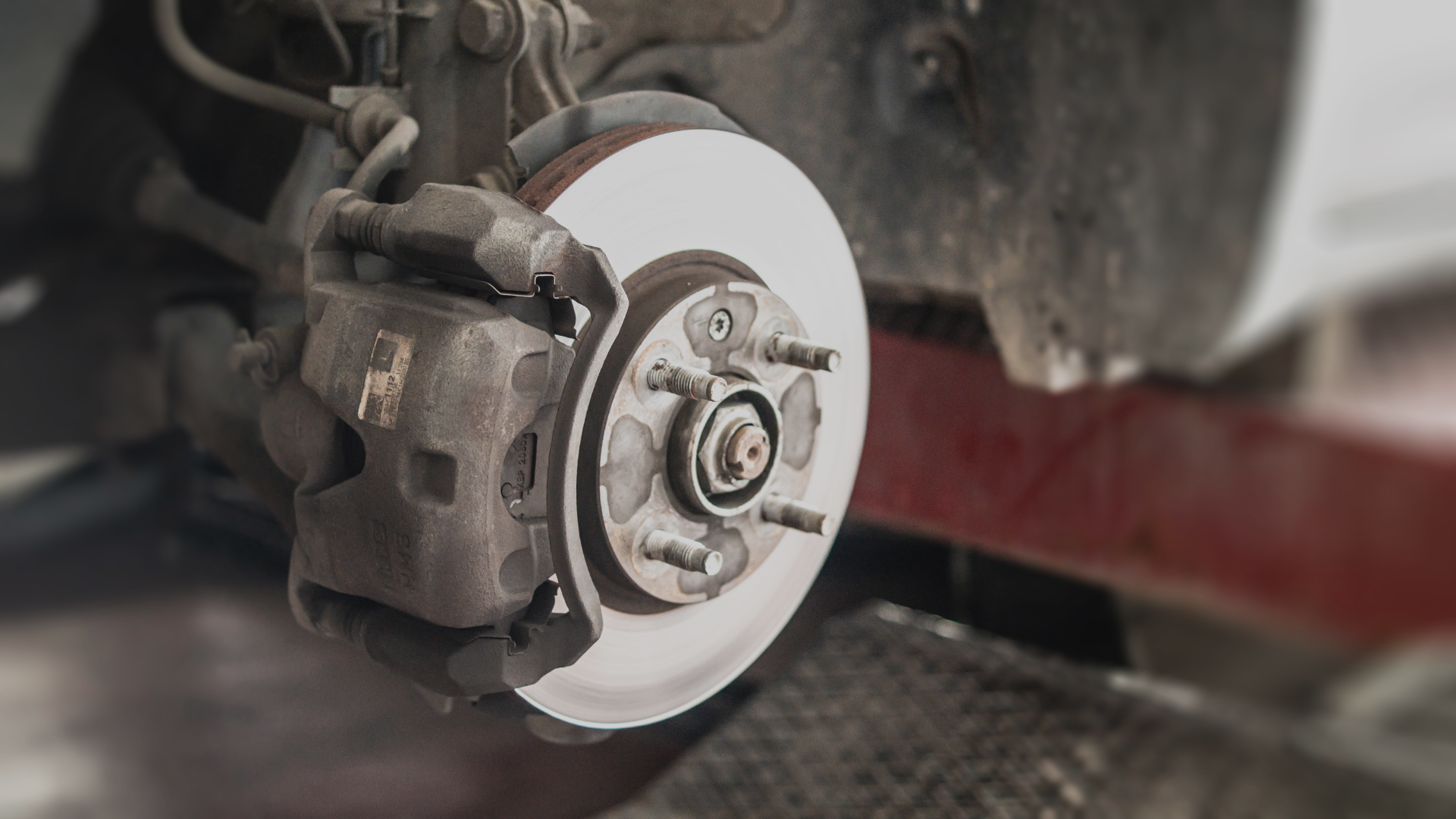 Up close image of a new brake pad in an auto body shop.