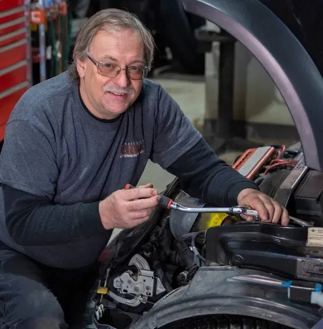 Mechanic Performing Vehicle Maintenance | Lancer Service