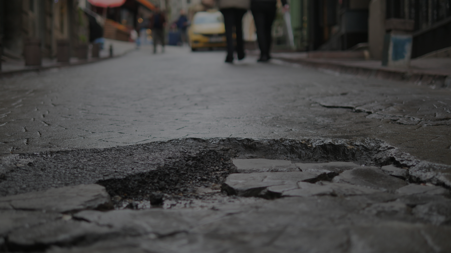 image of a pothole in a city road