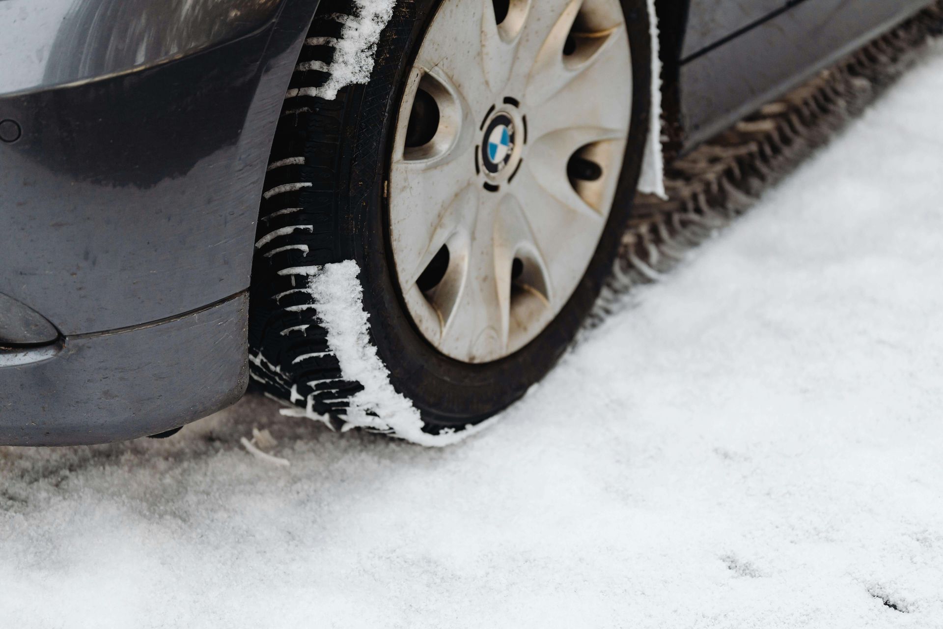Close up of a BMW tire on snowy ground