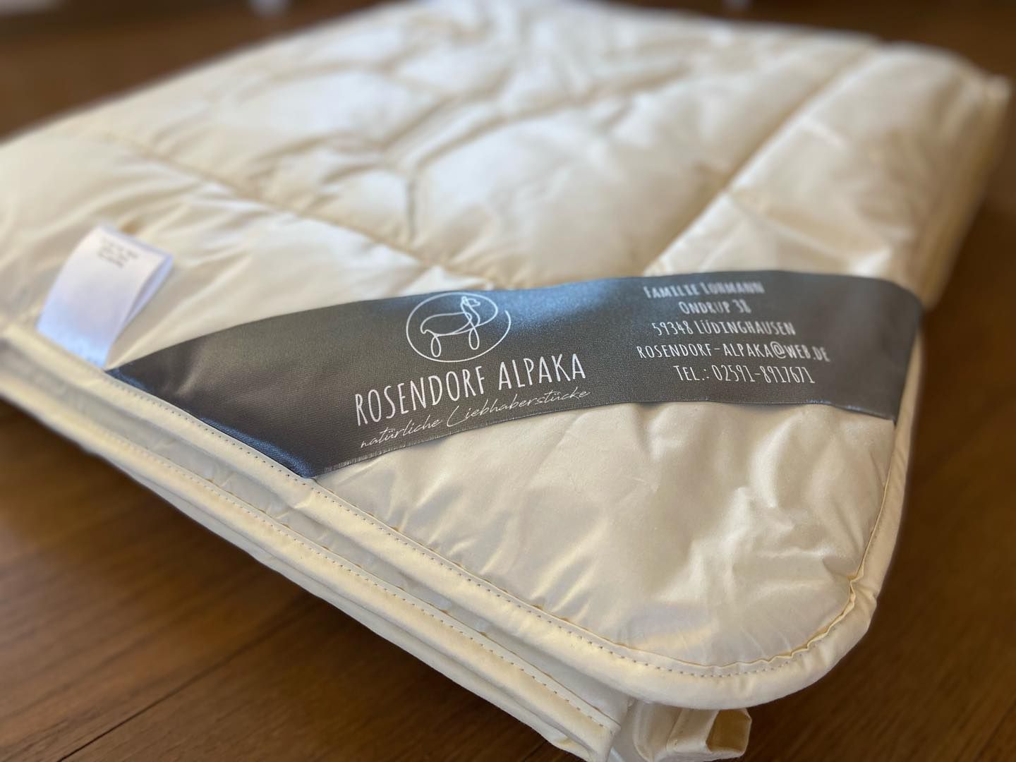 Eine weiße Decke mit einem Etikett mit der Aufschrift Rosendorf Alpaka