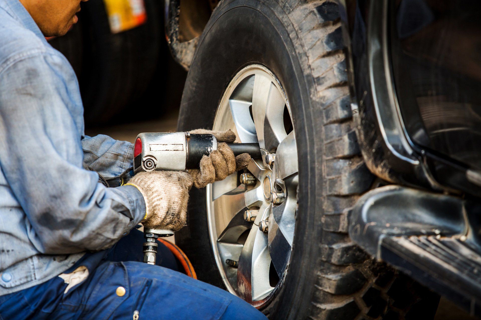Auto Shop In West Allis — Mechanic Changing Car Wheel in West Allis, WI
