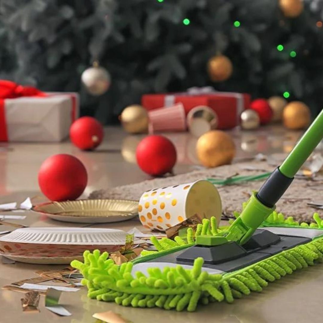 Mop cleaning up a mess after a holiday party, ornaments and gifts in the background.