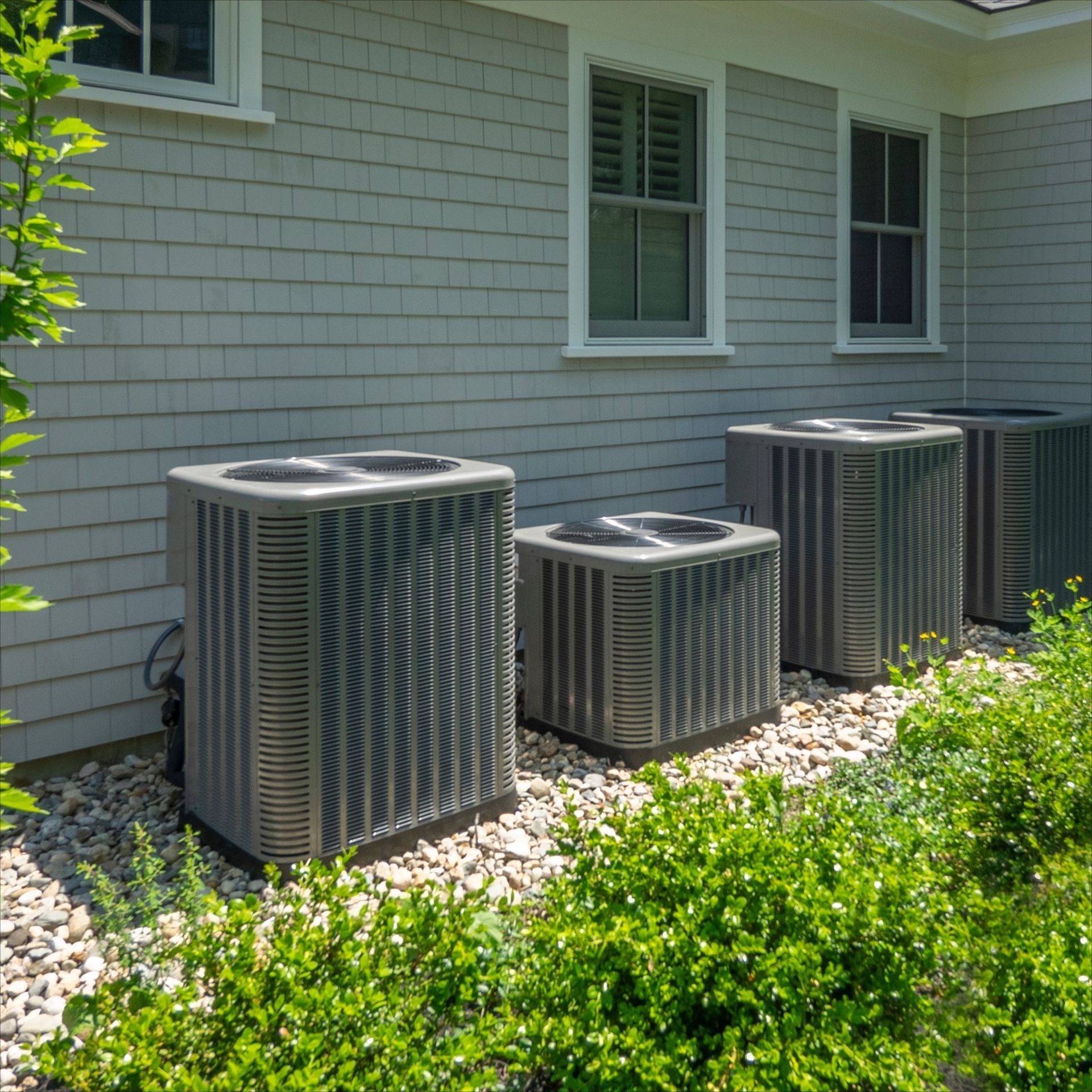 Goodman furnace in a basement setting. Gray metal with red logo and warning labels.