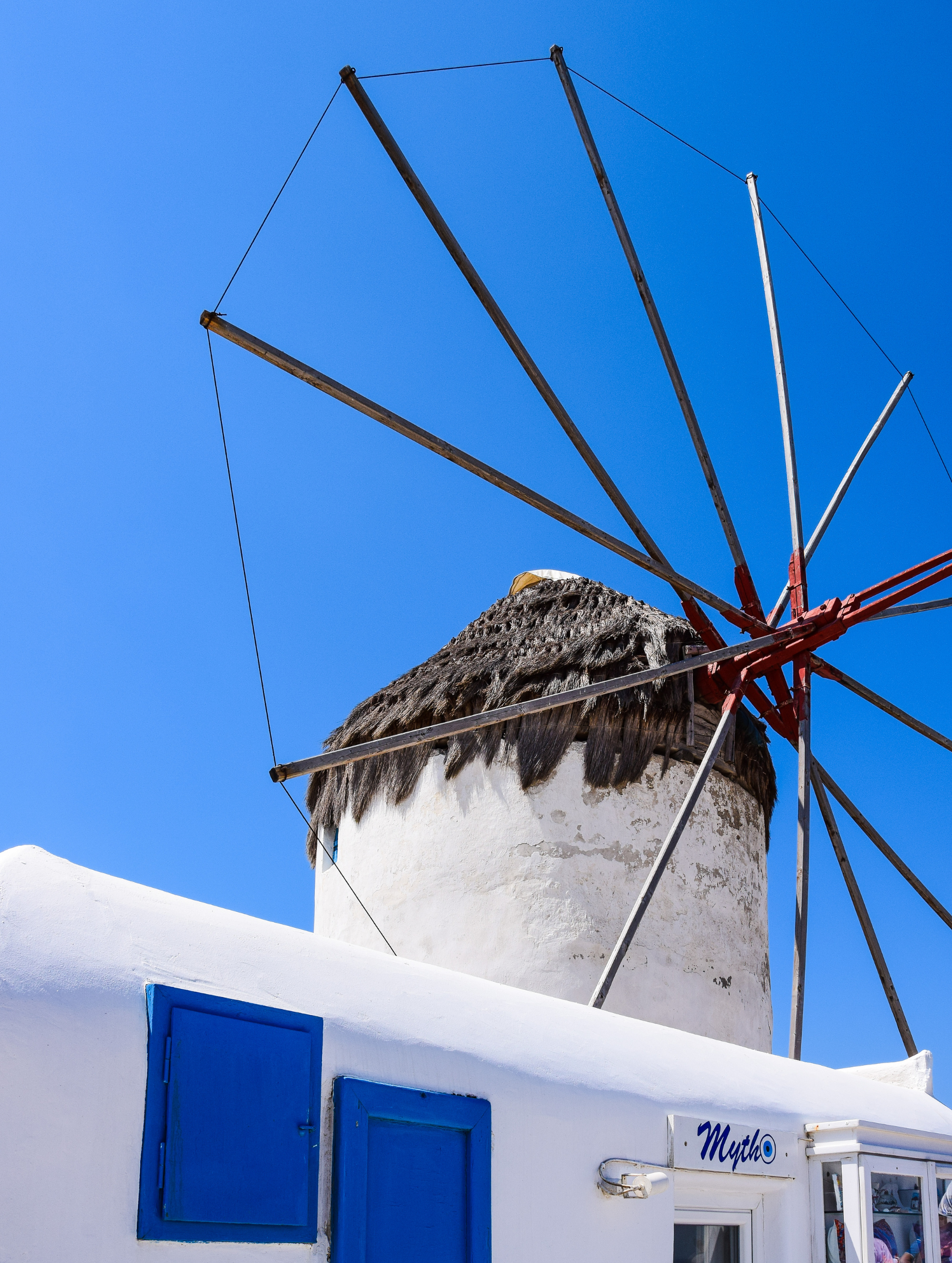 Iconic Mykonos windmills by the sea. Curated Mykonos yacht cruises